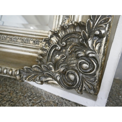 1483 - An ornate silver framed mirror