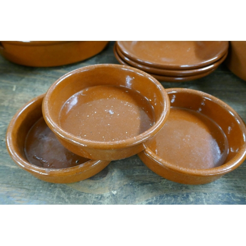 2466 - A collection of terracotta and Tappas cooking dishes