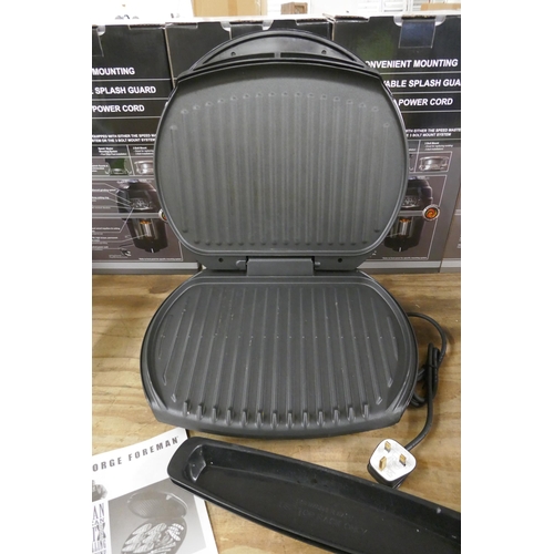 2493 - A George Foreman grill including trays and manual