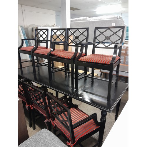 1542 - An ebonised extending dining table and eight chairs