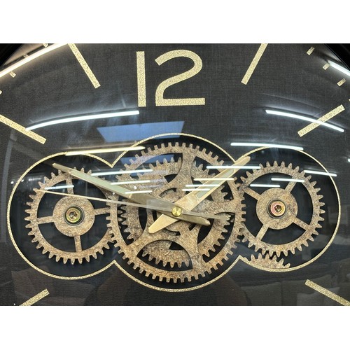 1498 - A black and gold moving gears wall clock