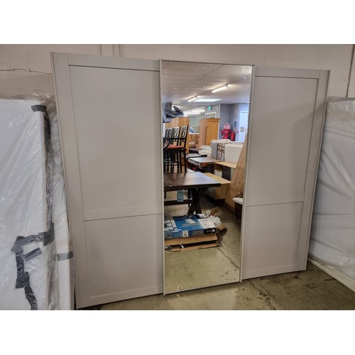 1547 - A large triple wardrobe with mirrored section * This lot is subject to VAT