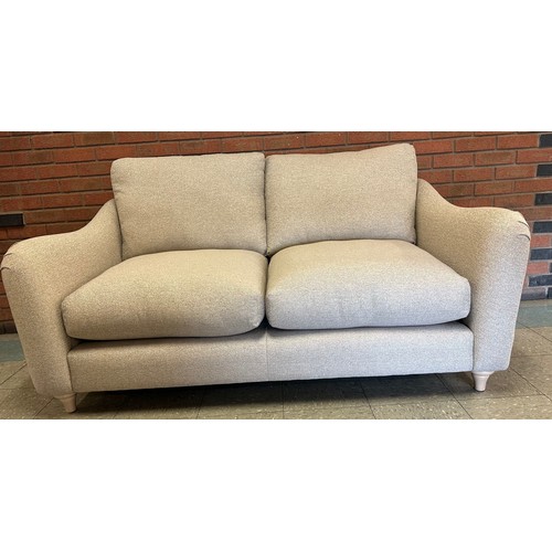 1350B - A Hattie Minco natural two seater sofa