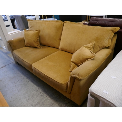 1615 - A turmeric velvet three seater sofa