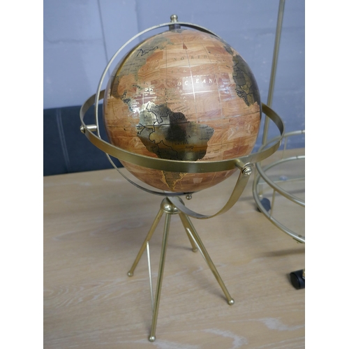 1629 - A globe on a stand and a gold painted two tier drinks trolley