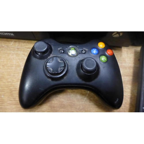 2091 - An Xbox 360 with one controller pad and power cable and an Xbox One with power cable - both black