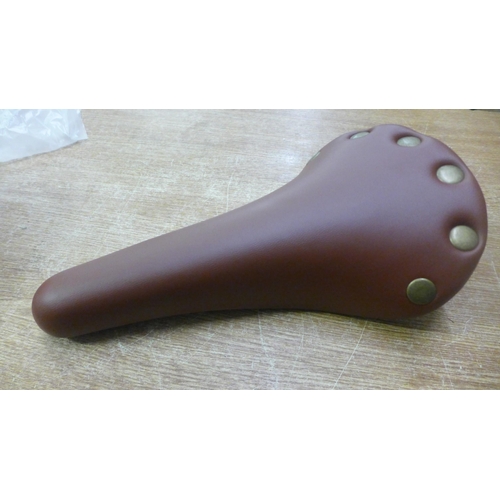 2105 - 2 Traditional style bike saddles in brown faux leather - unused