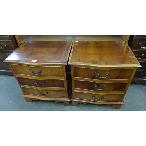 109 - A pair of George III style yew wood serpentine chests of drawers