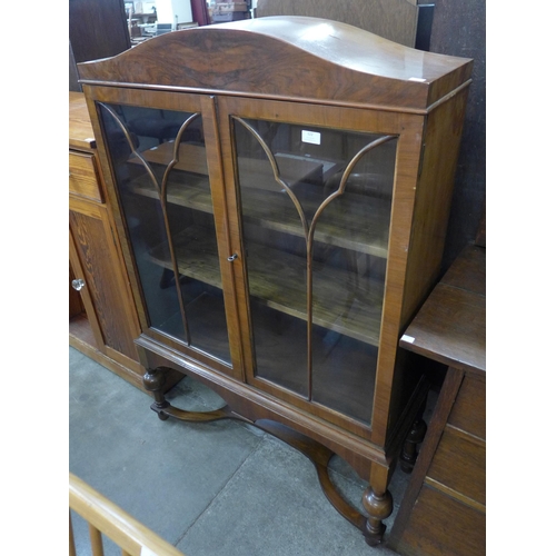 122 - A Queen Anne style walnut two door bookcase