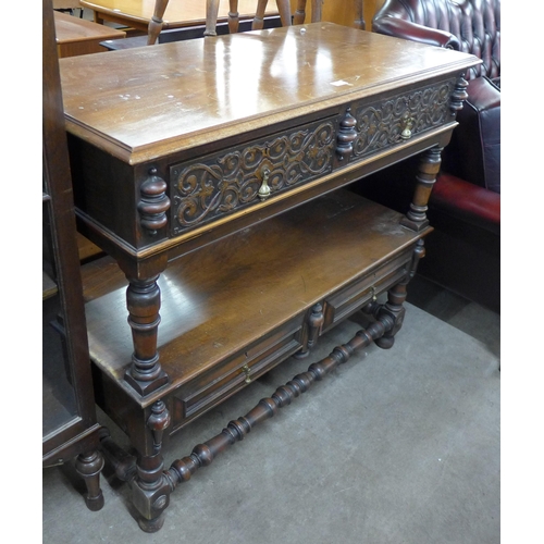 142 - A late Victorian Elizabethan Revival carved walnut two drawer buffet