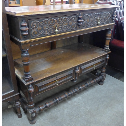 142 - A late Victorian Elizabethan Revival carved walnut two drawer buffet