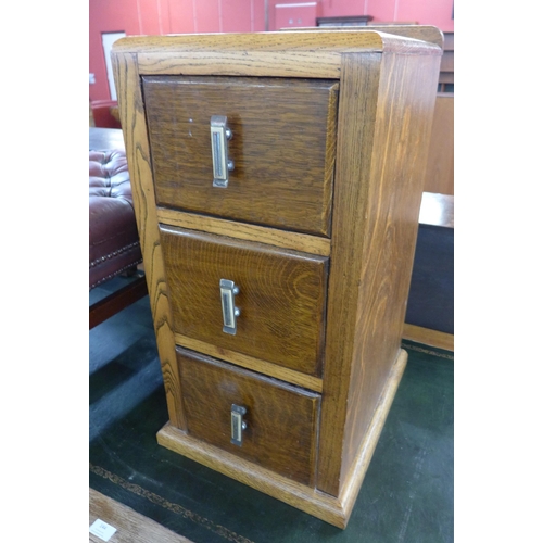 143 - A small Art Deco oak three drawer pedestal chest