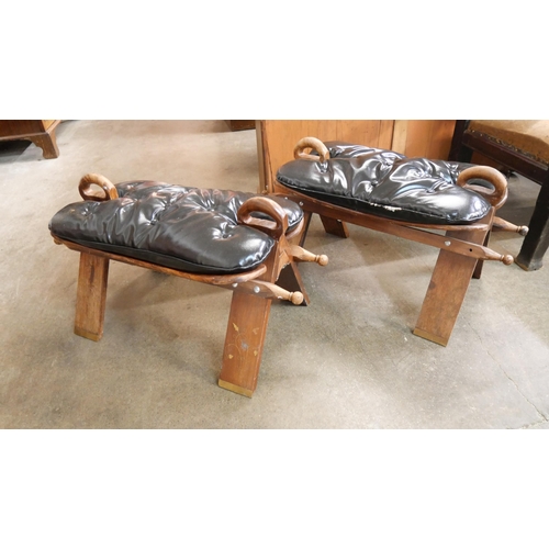 207 - A pair of beech and black leather camel stools