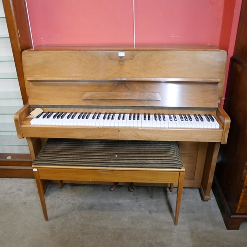 245 - A teak upright piano with faux ivory keys and a piano stool