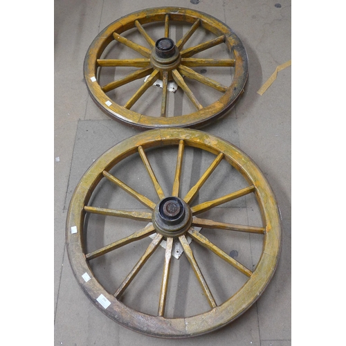 294 - A pair of wooden cart wheels