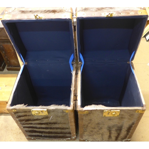 308 - A pair of hide covered and brass mounted trunks