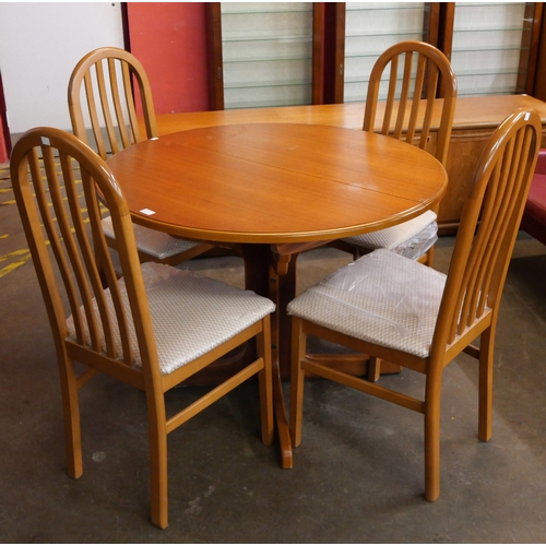 42 - A teak circular extending dining table and four chairs