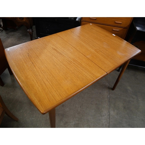 56 - A teak extending dining table