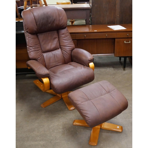 57 - A beech and brown leather revolving armchair and stool