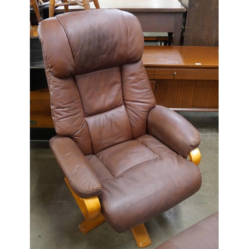 57 - A beech and brown leather revolving armchair and stool