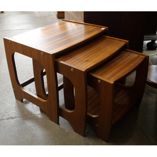 65 - A teak bedside cabinet, a nest of tables and a standard lamp