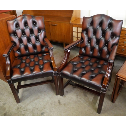 73 - A pair of mahogany and red oxblood leather Gainsborough style armchairs