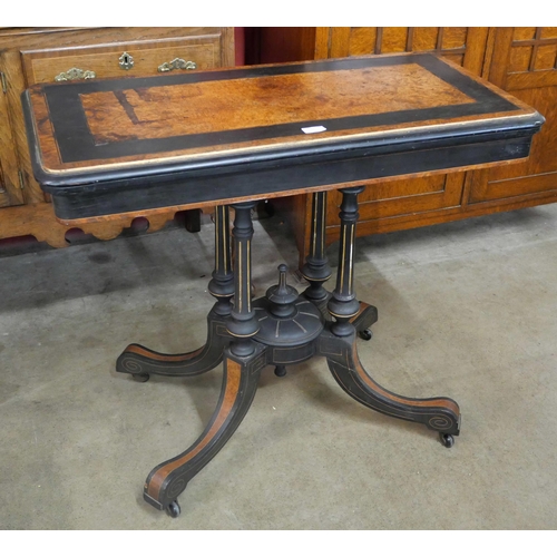 82 - A Victorian ebonised and amboyna rectangular fold over card table, manner of Lambs, Manchester