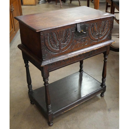 84 - A George II carved oak Bible box on stand, with two 19th Century Bibles