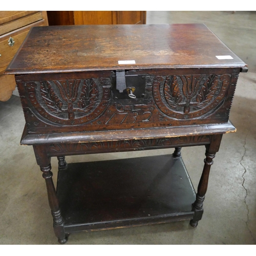 84 - A George II carved oak Bible box on stand, with two 19th Century Bibles