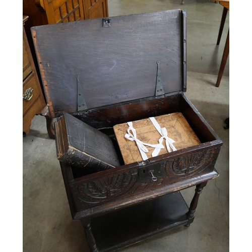 84 - A George II carved oak Bible box on stand, with two 19th Century Bibles