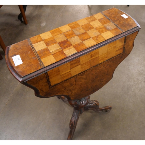 94 - A Victorian inlaid walnut drop leaf tripod games table