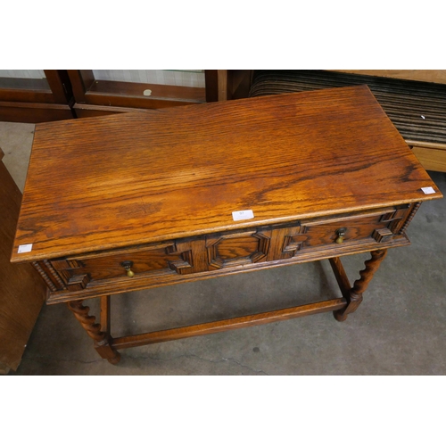 97 - An early 20th Century oak geometric moulded barleytwist single drawer single drawer side table