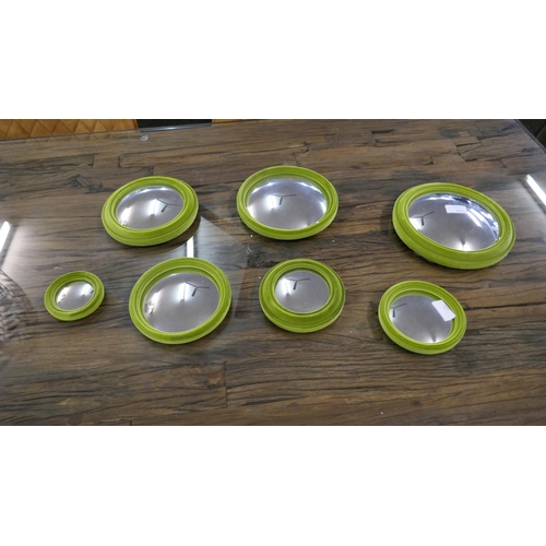 1306 - A set of seven lime green flocked convex mirrors