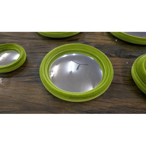 1306 - A set of seven lime green flocked convex mirrors