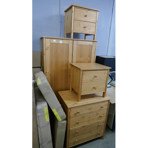 1554 - A pine wardrobe, a chest of drawers and a pair of bedside chests - boxed * this lot is subject to VA... 