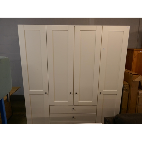 1556 - A four door white wardrobe with built in chest of drawers - marked * this lot is subject to VAT