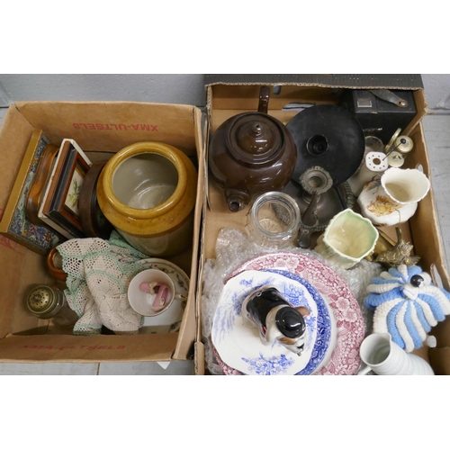 1058 - Two boxes of assorted china, metalwares, needleworks and a Manor Collectibles model of a British Bul... 