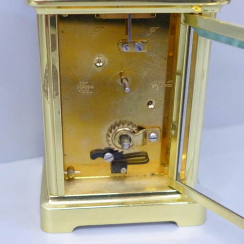 616 - An English brass and four glass sided carriage clock