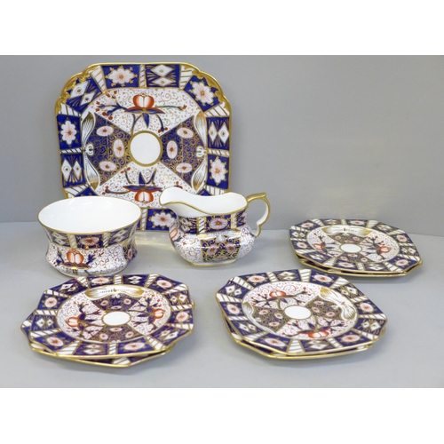 625 - A Carlton Ware Imari pattern sandwich set; a large plate and six small plates, milk and sugar