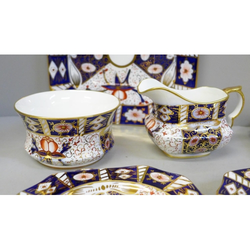 625 - A Carlton Ware Imari pattern sandwich set; a large plate and six small plates, milk and sugar