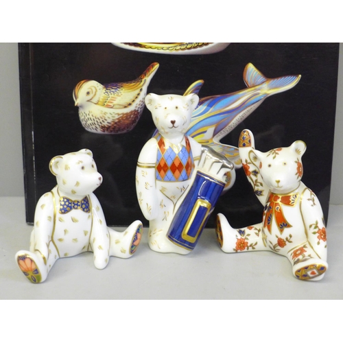 633 - Three Royal Crown Derby paperweights, Golfer Bear, two others and a Collector's Guide