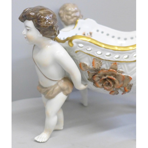 638 - A continental porcelain hand painted four cherub centrepiece, 34cm