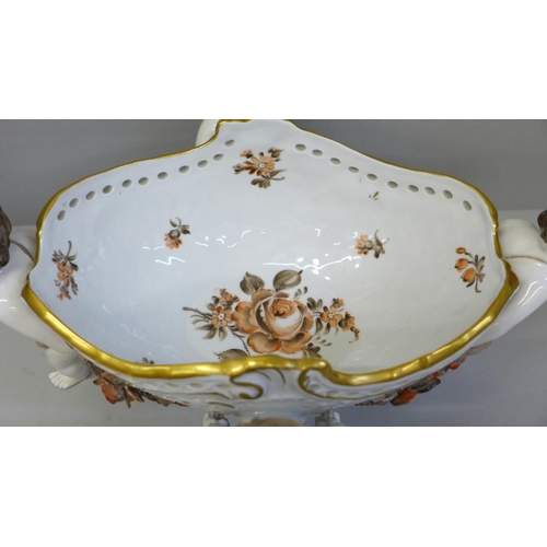 638 - A continental porcelain hand painted four cherub centrepiece, 34cm