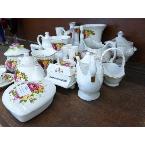 661 - A large quantity of Cottage Rose china, including a swan, iron, bell, vases, etc., two Staffordshire... 