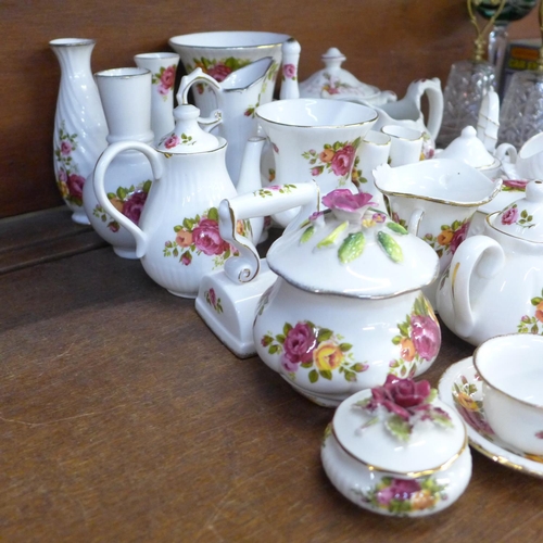 661 - A large quantity of Cottage Rose china, including a swan, iron, bell, vases, etc., two Staffordshire... 