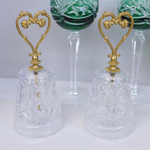 662 - Four Bohemian green glass cut wine glasses and matching bell, two crystal bells with gilded heart ha... 