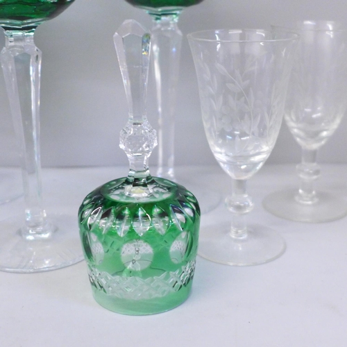 662 - Four Bohemian green glass cut wine glasses and matching bell, two crystal bells with gilded heart ha... 