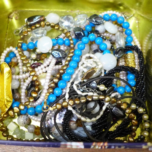 665 - A basket of costume jewellery and watches