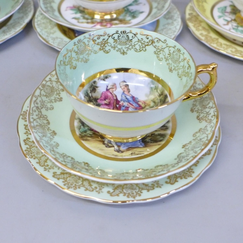 669 - An Ashley bone china set of six cups, saucers and tea plates, decorated with fruit and with 22kt gol... 