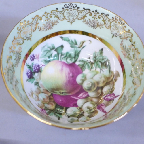 669 - An Ashley bone china set of six cups, saucers and tea plates, decorated with fruit and with 22kt gol... 